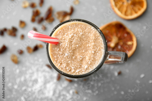 Glass cup of tasty frappe coffee on grey table, closeup