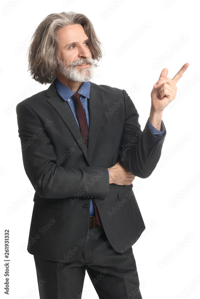 Handsome mature businessman pointing at something on white background Handsome mature businessman pointing at something on white background