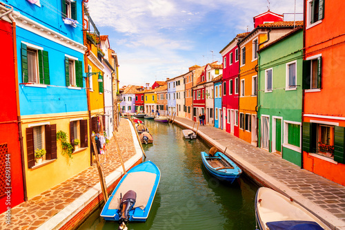 Colorful houses in Burano near Venice, Italy with boats, canal and tourists. Famous tourist attraction in Venice. © Nikolay N. Antonov