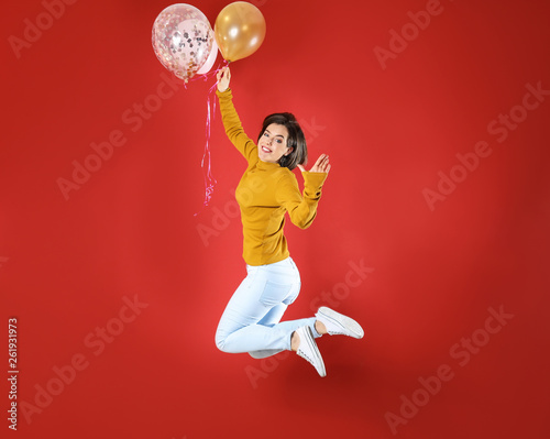 Jumping young woman with ai...