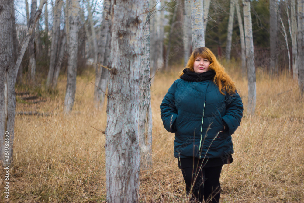 The red-haired girl plus size autumn on the street. The red-haired girl plus size autumn on the street.