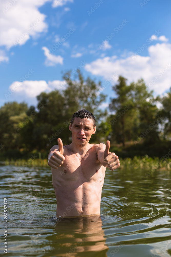 Fototapeta premium Portrait of a handsome young man in the water.