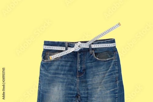 Jeans with a measuring tape. Weight loss concept