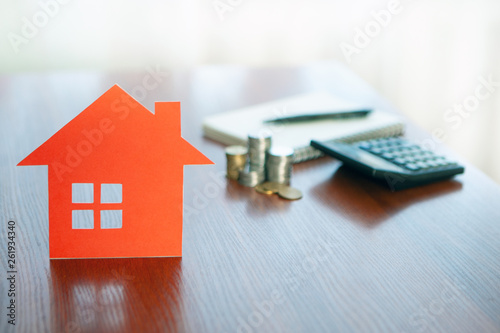 Buying and selling houses and real estate prices. Concept. Man using calculator to count rent money. 