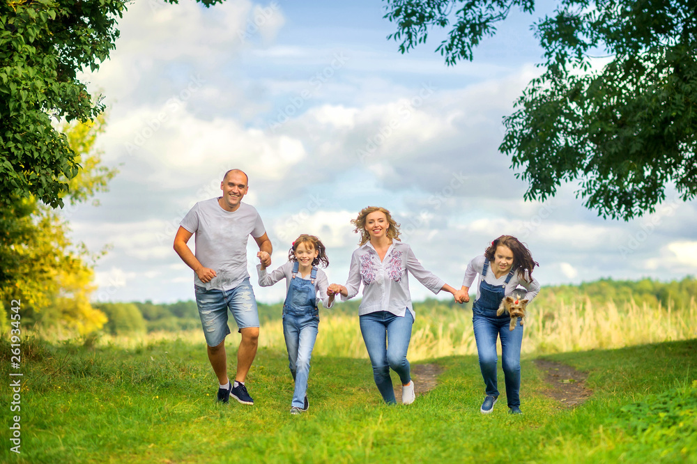 Obraz premium Loving family. Happy young family spending time together having fun in summer park, people concept. Family еnjoying time together