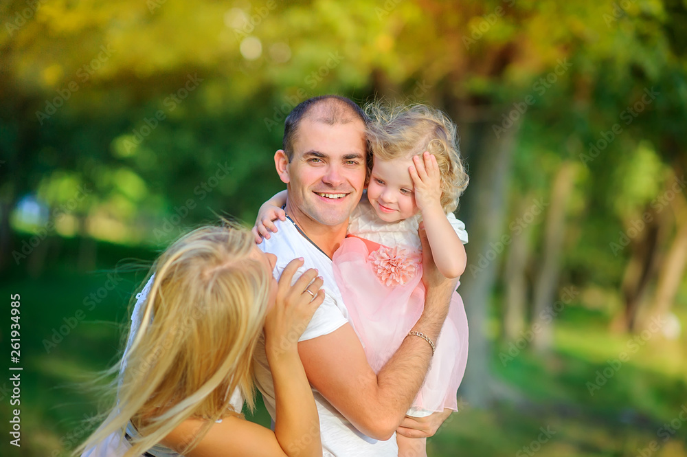 Loving family. Father holds in his arms and gently hugs daughter Loving family. Father holds in his arms and gently hugs daughter