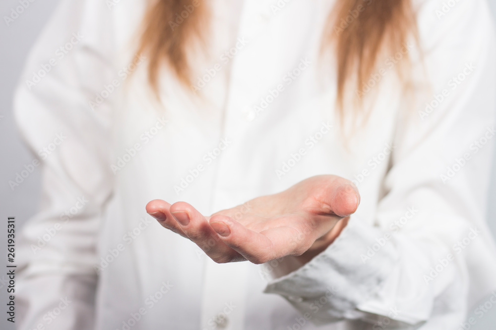 A girl in a white shirt holds in front of her hand palm up. Pose cup. A girl in a white shirt holds in front of her hand palm up. Pose cup.