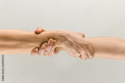 Better together. Male hands demonstrating a gesture of holding and strong isolated on gray studio background. Concept of human relations, friendship, partnership, business, Copyspace.
