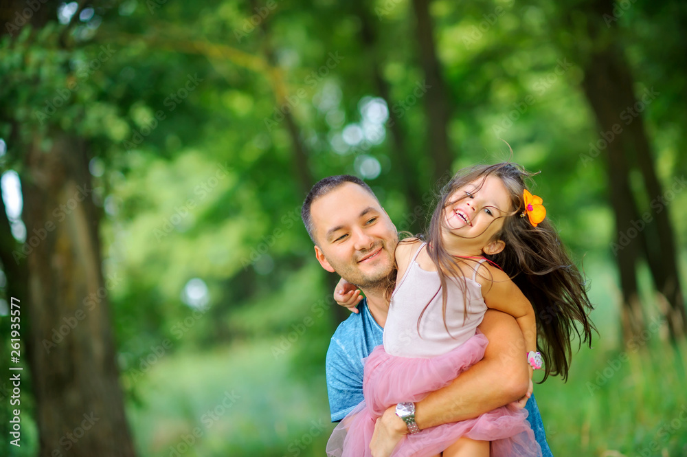 family is having fun. Dad plays with his daughter in the evening park. people concept. Family enjoy time together family is having fun. Dad plays with his daughter in the evening park. people concept. Family enjoy time together