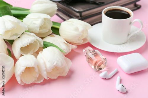 Composition with beautiful tulips, female accessories and cup of coffee on color background
