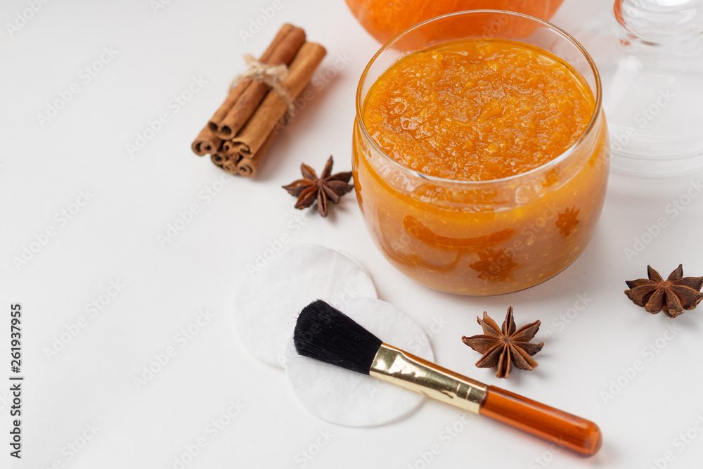 Homemade pumpkin face mask . Home cosmetics with their hands , brush for application on a white background