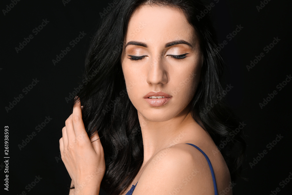 Portrait of beautiful woman on dark background