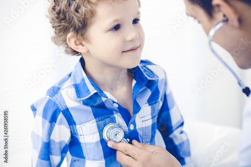 Doctor and patient child. Physician examining little boy. Regular medical visit in clinic. Medicine and health care concept