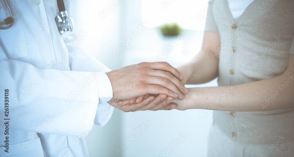 Hand of doctor reassuring her female patient. Medicine and health care concept Hand of doctor reassuring her female patient. Medicine and health care concept