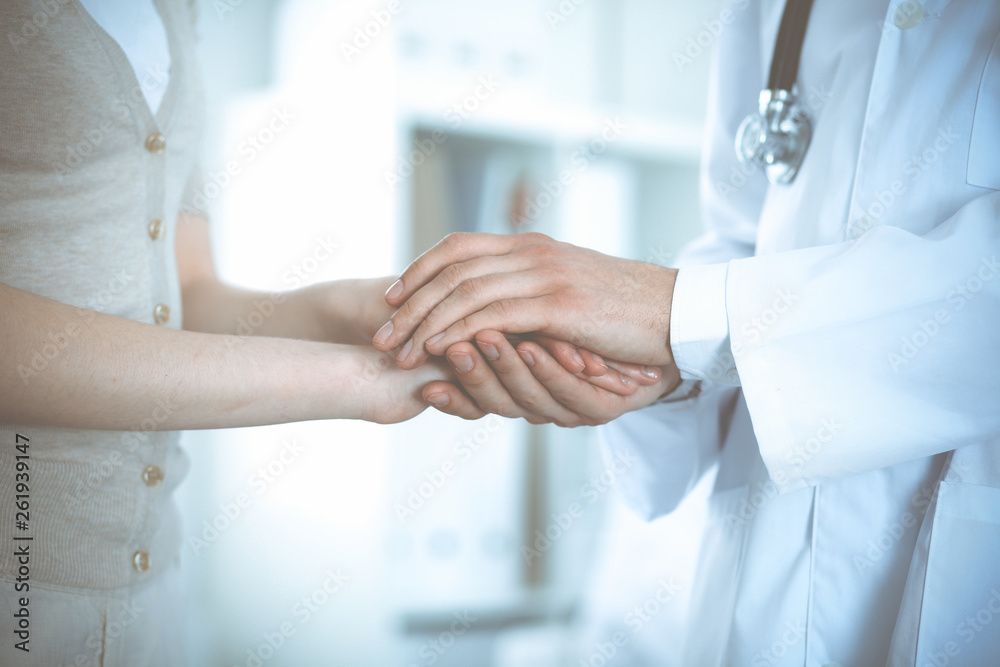Hand of doctor reassuring her female patient. Medicine and health care concept Hand of doctor reassuring her female patient. Medicine and health care concept