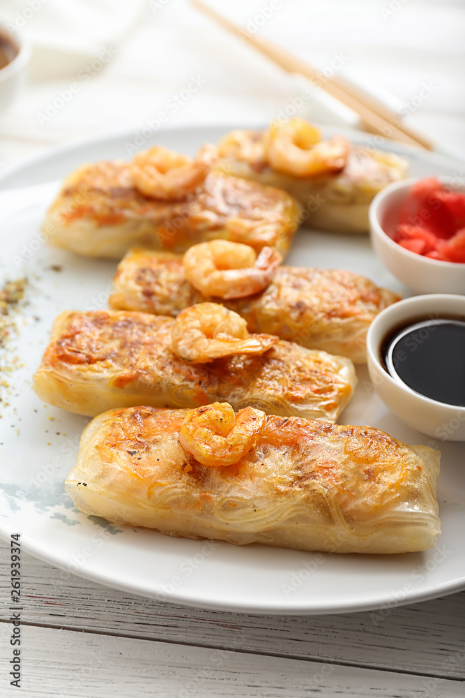 Plate with tasty fried spring rolls on table Plate with tasty fried spring rolls on table