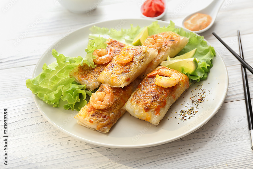 Plate with tasty fried spring rolls on table Plate with tasty fried spring rolls on table