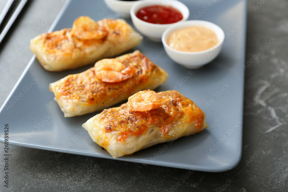 Plate with tasty fried spring rolls on table Plate with tasty fried spring rolls on table
