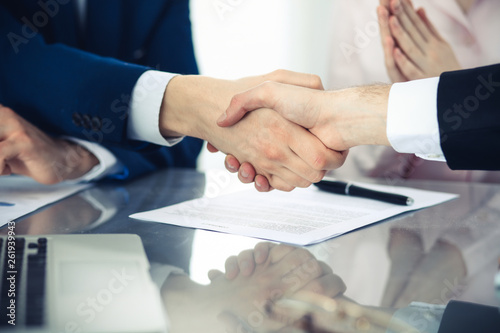 Business people shaking hands finishing up a meeting. Handshake at successful negotiation