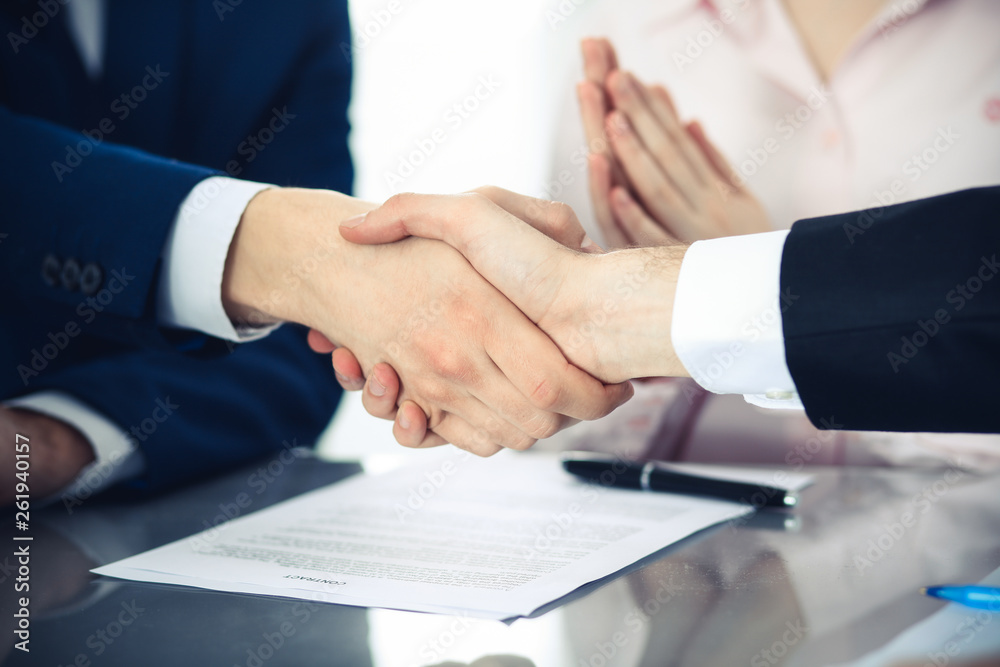 Business people shaking hands finishing up a meeting. Handshake at successful negotiation Business people shaking hands finishing up a meeting. Handshake at successful negotiation
