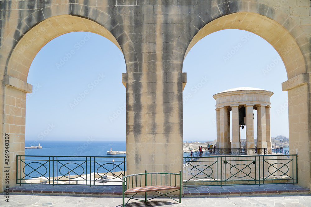 World War II Siege Bell War Memorial through arches in the Lower Barrakka Gardens, Valletta, Malta