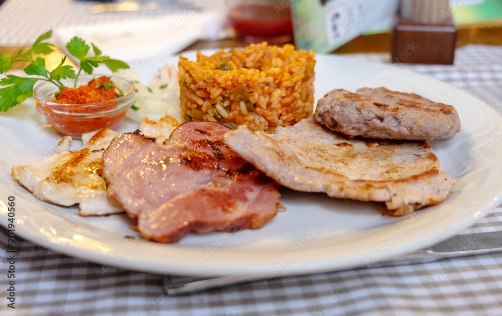 Assorted fried meats (chicken, lamb, beef) and fried rice, served at restaurant Assorted fried meats (chicken, lamb, beef) and fried rice, served at restaurant