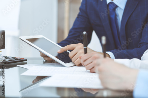 Businessman using laptop at meeting, closeup of hands. Business operations concept