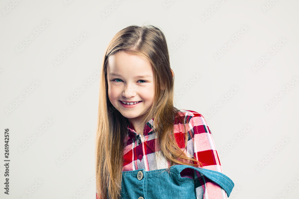 portrait of a happy child. little girl smiles and shows emotion. studio fashion kid shooting. portrait of a happy child. little girl smiles and shows emotion. studio fashion kid shooting.