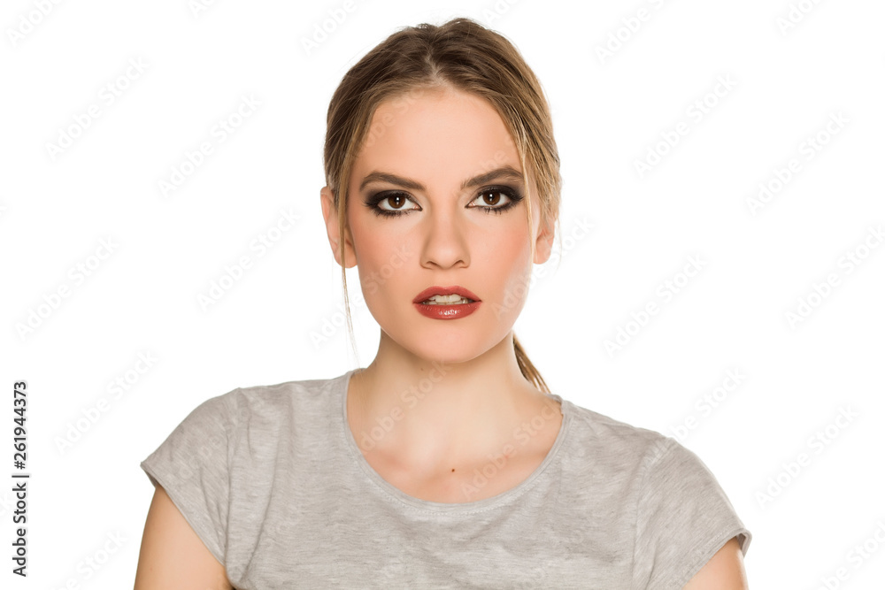 Young woman with makeup, posing on white background Young woman with makeup, posing on white background