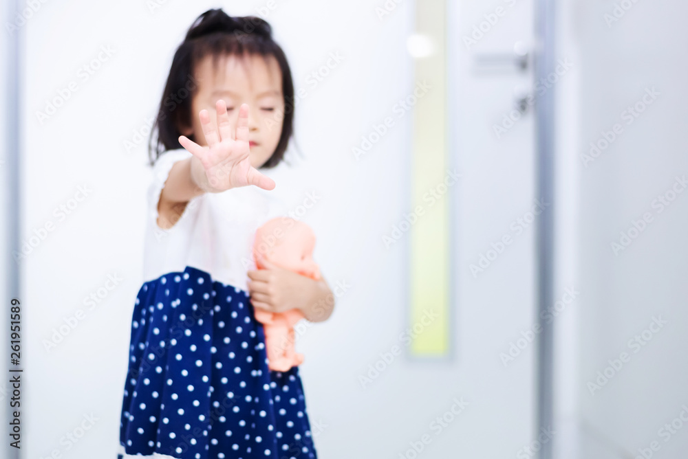 Little baby child holding baby doll afraid to walk out the door Little baby child holding baby doll afraid to walk out the door