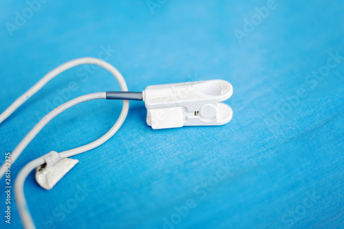 Fingertip Pulse Oximeter for oxyhemoglobin on blue background photo