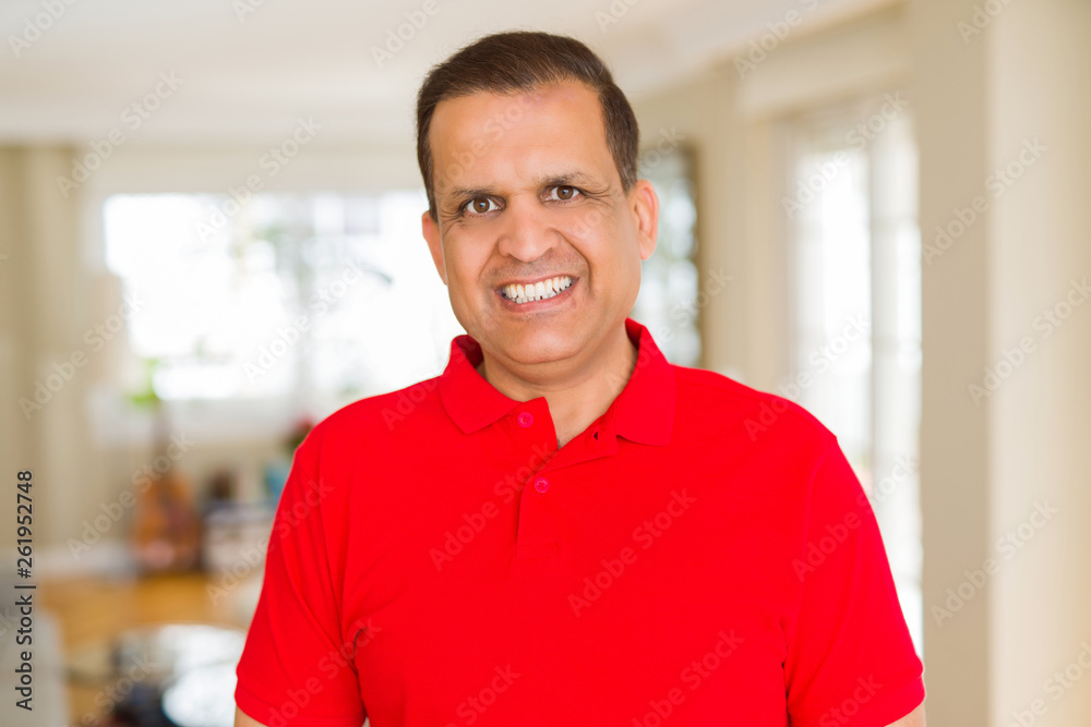 Middle age man smiling confident to the camera at home Middle age man smiling confident to the camera at home