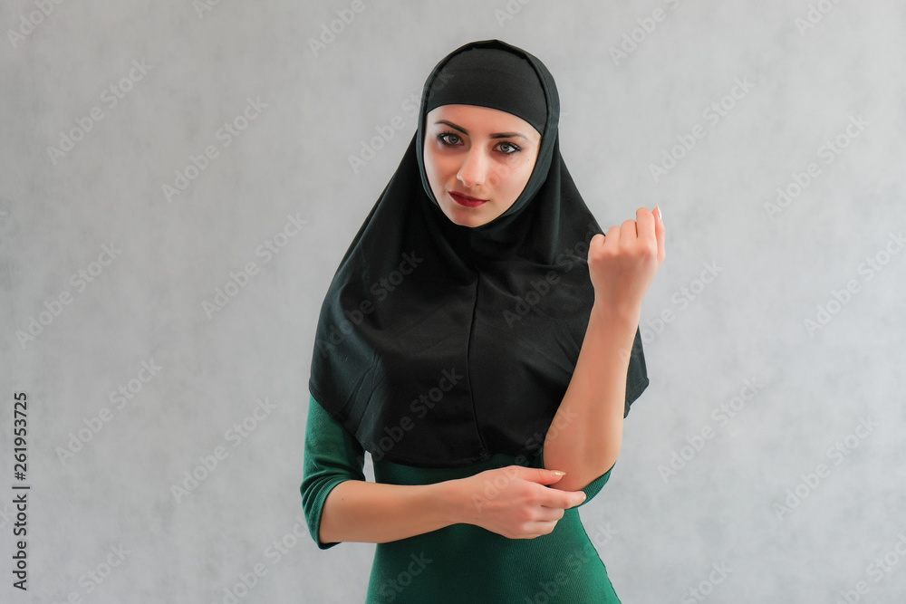 Concept Beauty sexy fashion model woman in hijab portrait, with long beautiful hair on black background standing. Beautiful young brunette girl posing in studio. Concept Beauty sexy fashion model woman in hijab portrait, with long beautiful hair on black background standing. Beautiful young brunette girl posing in studio.
