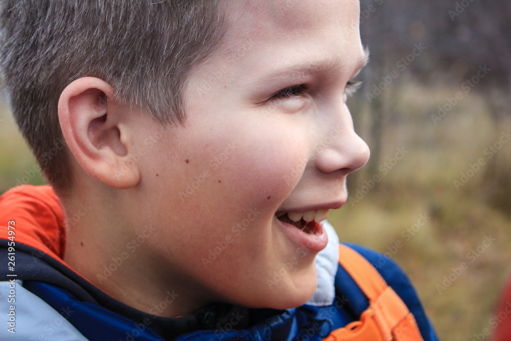 The boy is blond with green eyes. Portrait of a cheerful boy, wide smile The boy is blond with green eyes. Portrait of a cheerful boy, wide smile