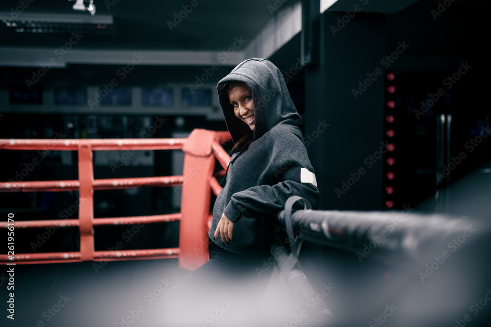 Φωτογραφία Badass powerful caucasian female boxer posing in ring with hoodie on head