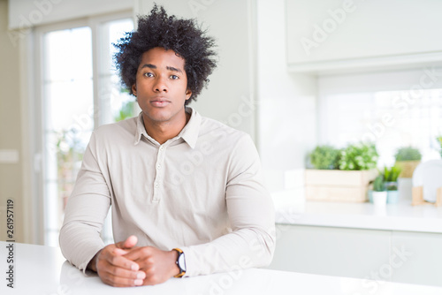 African American man at home Relaxed with serious expression on face. Simple and natural looking at the camera.