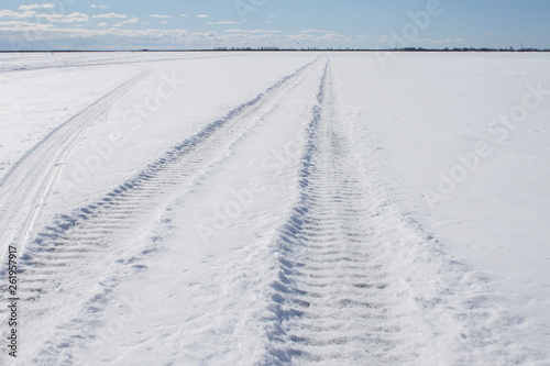 winter landscape wheel print in the snow, going beyond the horizon © eevlada