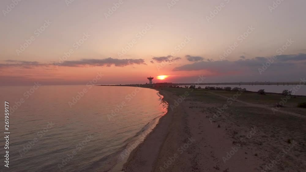 Red sunset on the beach against the background of a space antenna. Evpatoria, Crimea. Red sunset on the beach against the background of a space antenna. Evpatoria, Crimea.
