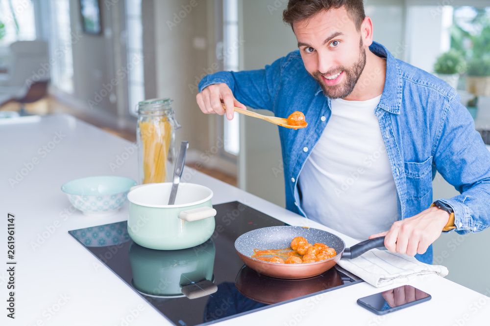 Handsome man cooking pasta at home Handsome man cooking pasta at home