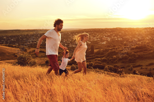 Happy family having fun walking in nature. © Studio Romantic