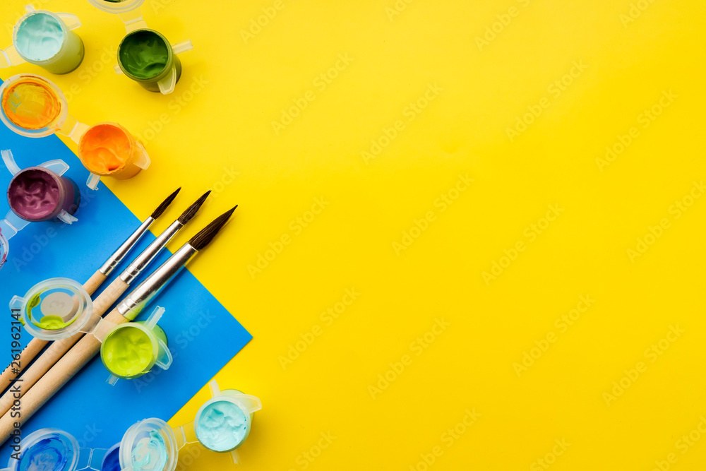 Flat lay composition with different acrilic or oil paints and brushes on grunge background. Flat lay composition with different acrilic or oil paints and brushes on grunge background.