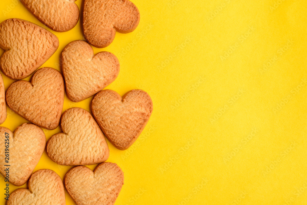 Heart-shaped cookies on yellow background Heart-shaped cookies on yellow background