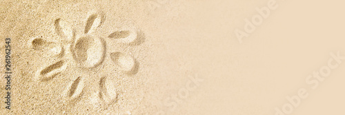 Drawing of a sun in the sand of a beach, summer vacations travel panoramic background and web banner with copy space