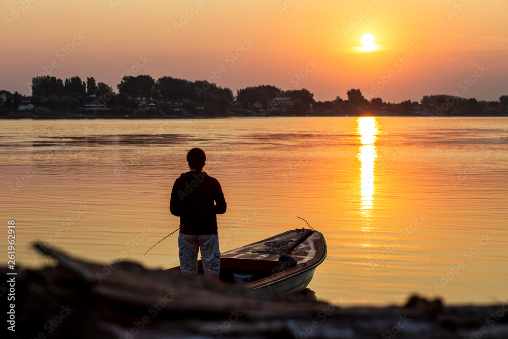 Fisherman.  Young man fishing on the river.