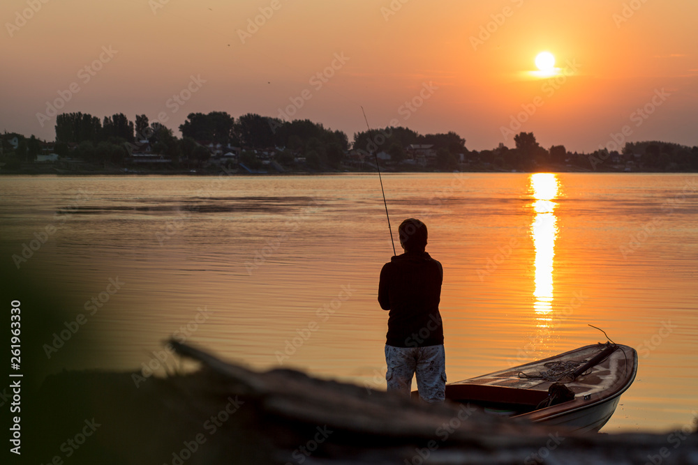 Fisherman.  Young man fishing on the river.