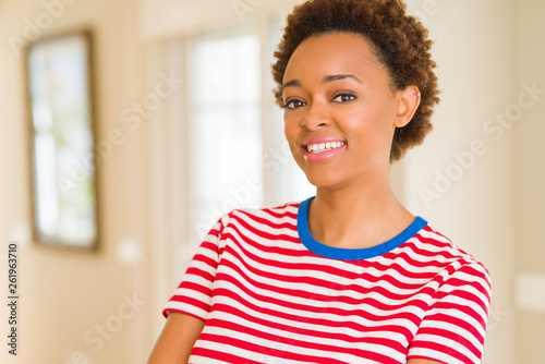 Beautiful young african american woman smiling confident to the camera showing teeth