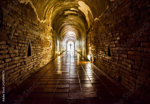 Silhouette of the cross at the end of tunnel