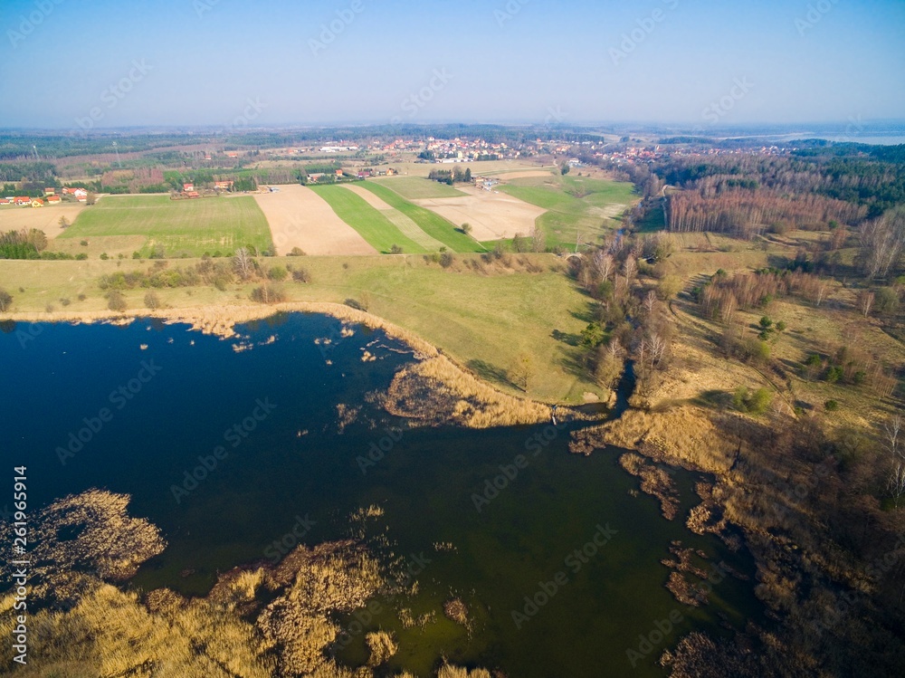 Aerial view of Patelnia Lake in Mazury district. Next destroyed railway bridge over Sapina river and Kruklanki town, Poland (former Kruglanken, East Prussia)