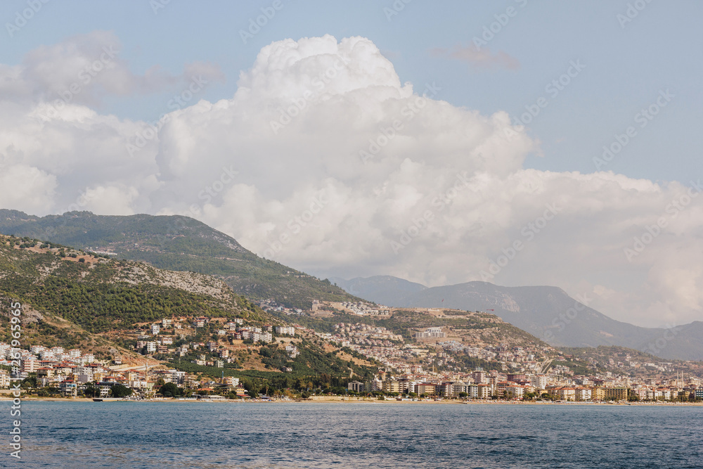 the coastline on the background of the city and mountains