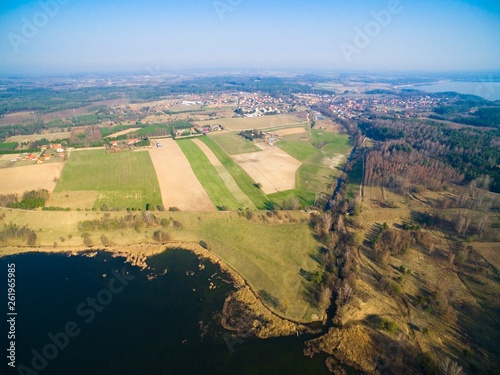 Aerial view of Patelnia Lake in Mazury district. Next destroyed railway bridge over Sapina river and Kruklanki town, Poland (former Kruglanken, East Prussia)